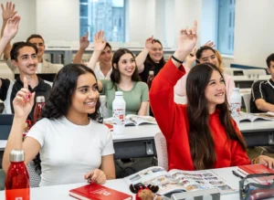 Students raising their hands in an ILAC classroom.