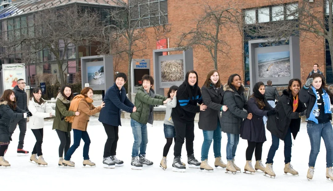 ILAC students ice skating outdoors in a line at a school field trip